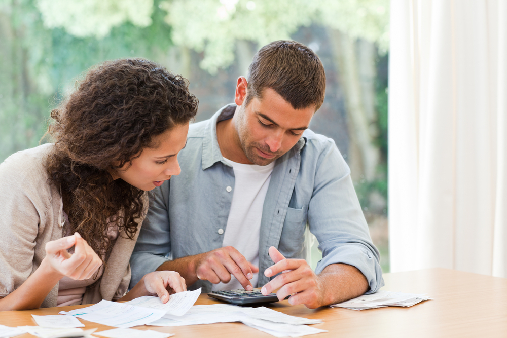 Couple looking at bills - types of debt repayment