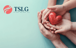 unmarried parents Child support payments in California portrayed by the parents hands holding child hands holding a model heart.